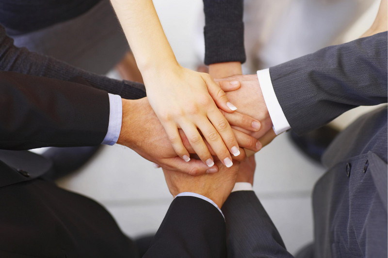 Business People Joining Hands In Circle
